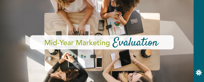 four people at work sitting around a table doing a mid-year marketing evaluation - read our blog post