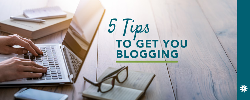 laptop, reading glasses, and a person typing their next blog post